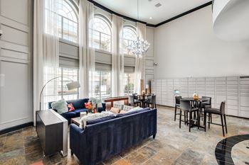 A large bedroom with a bed, chairs, and a dining table.